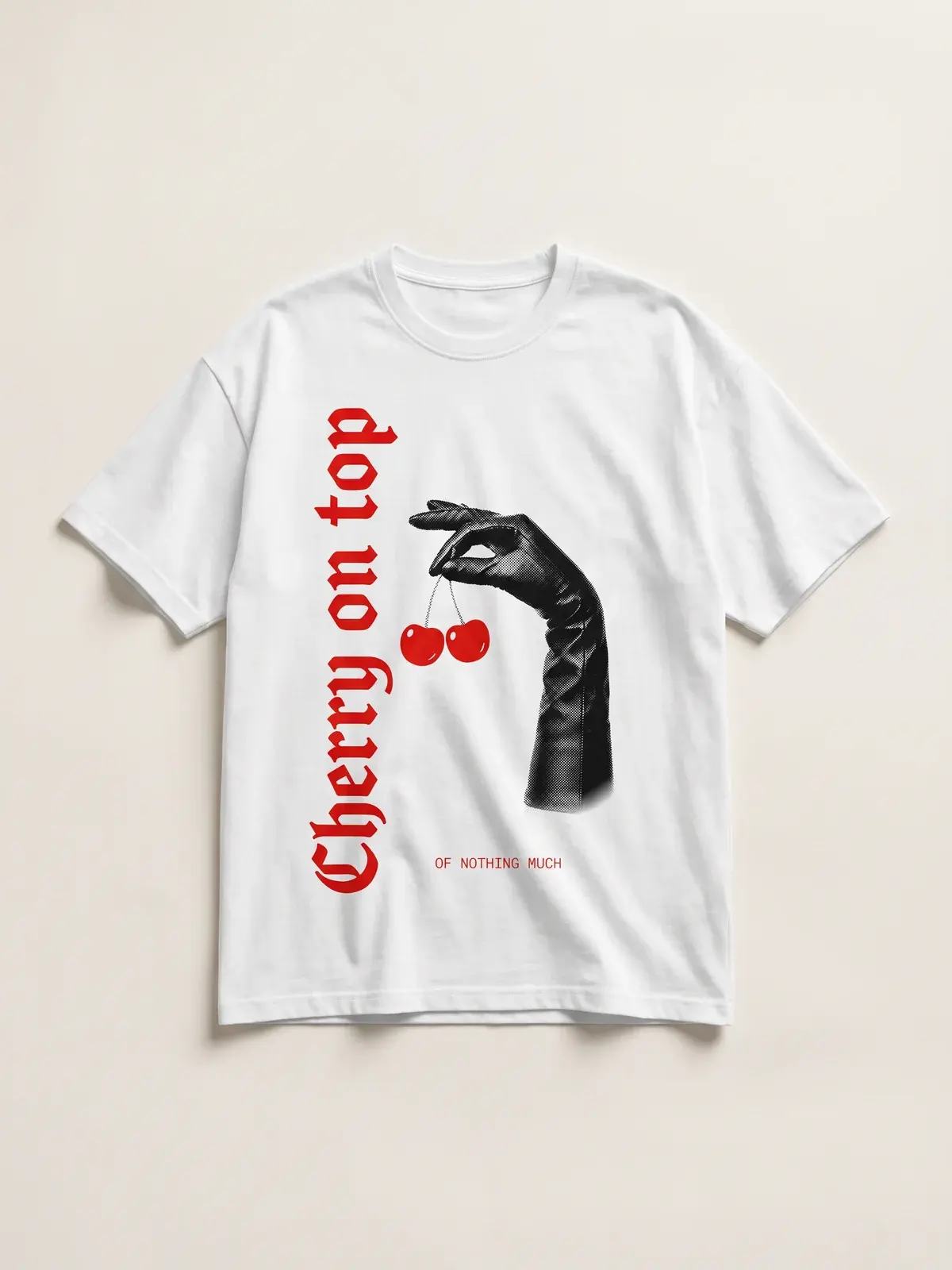 The Cherry on top tee laid flat on paper